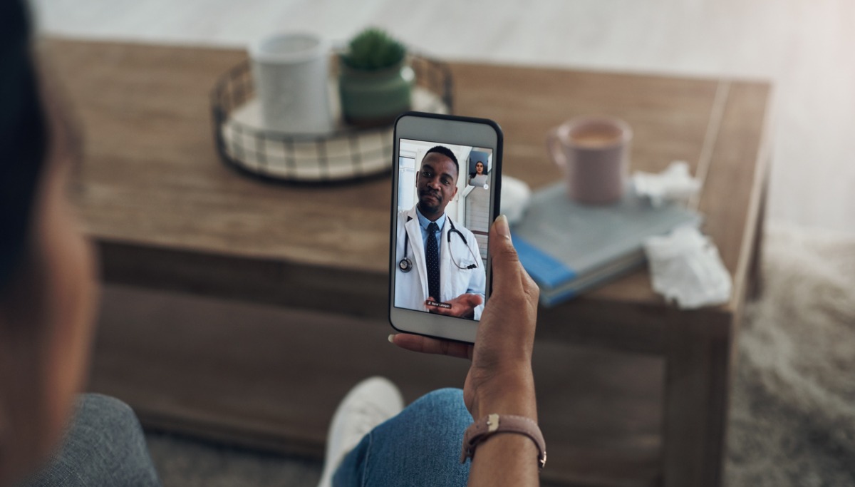 A patient having a video call with their dentist