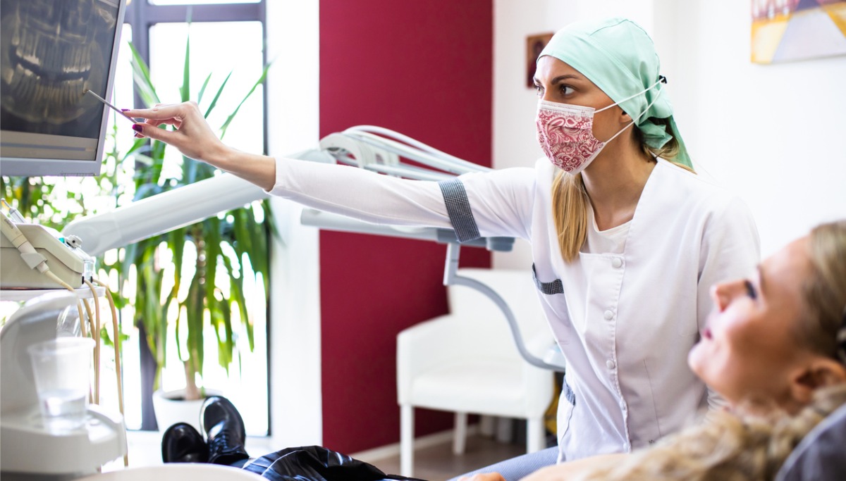 A dentist showing a patient an xray