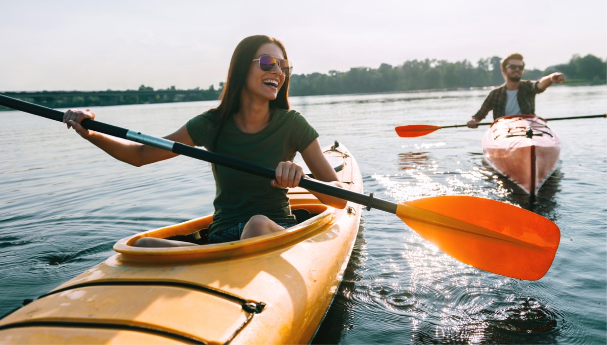 A couple kayaking in the sun