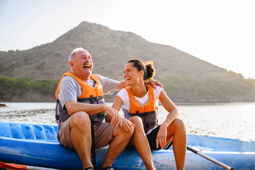 Two family members laughing while sitting on a kayak