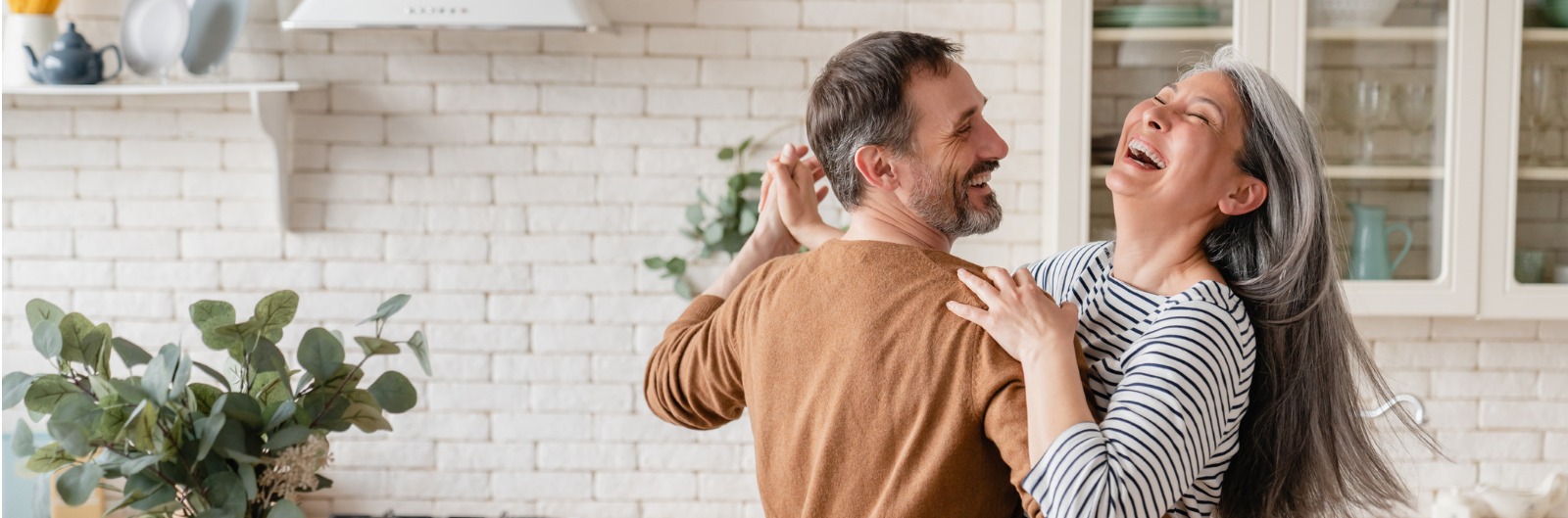 A couple dancing in their kitchen