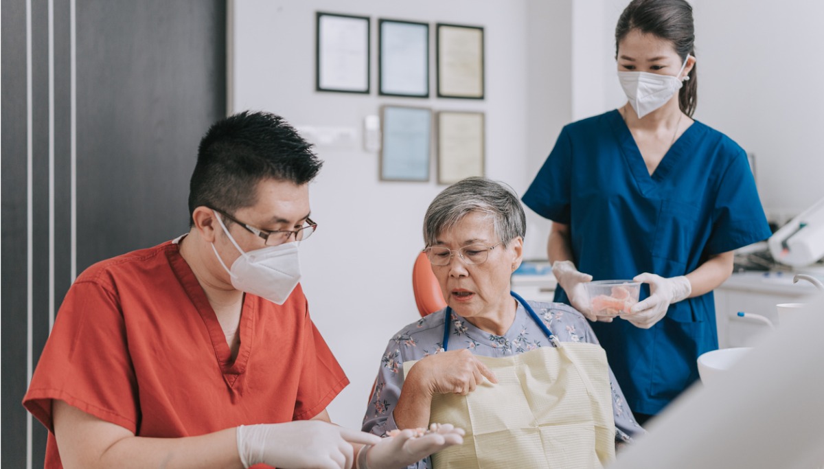 A dentist and patient discussing a dental bridge