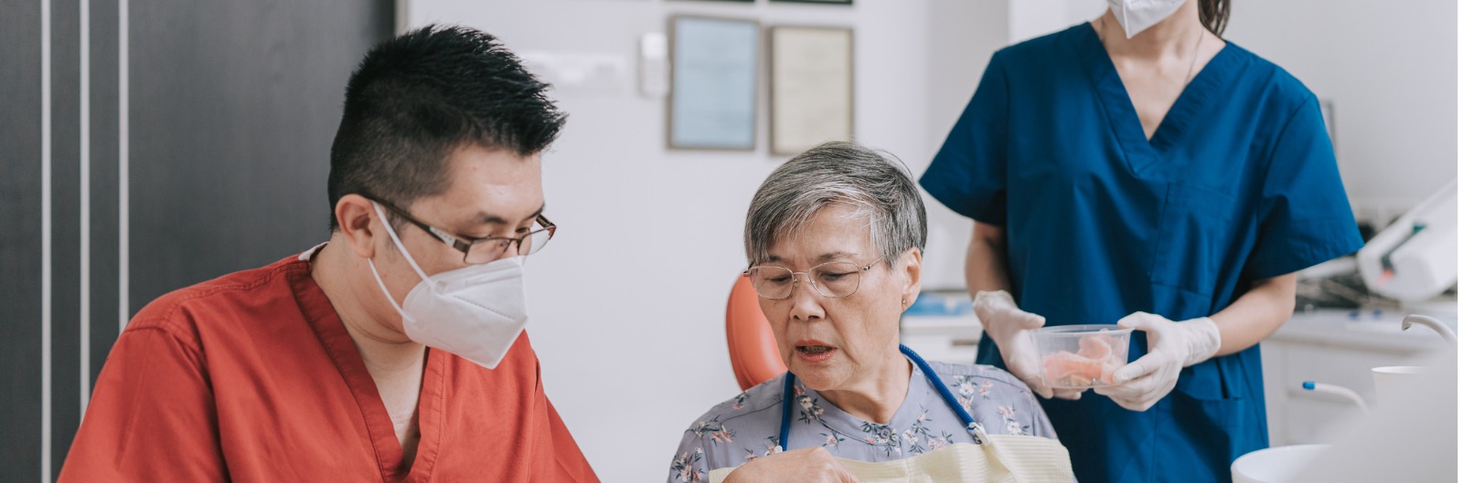 A dentist and patient discussing a dental bridge